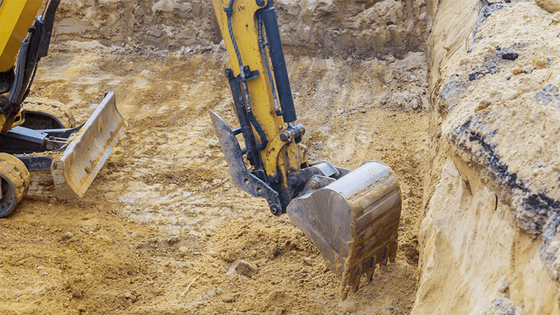 An Excavator Digging A Foundation Trench